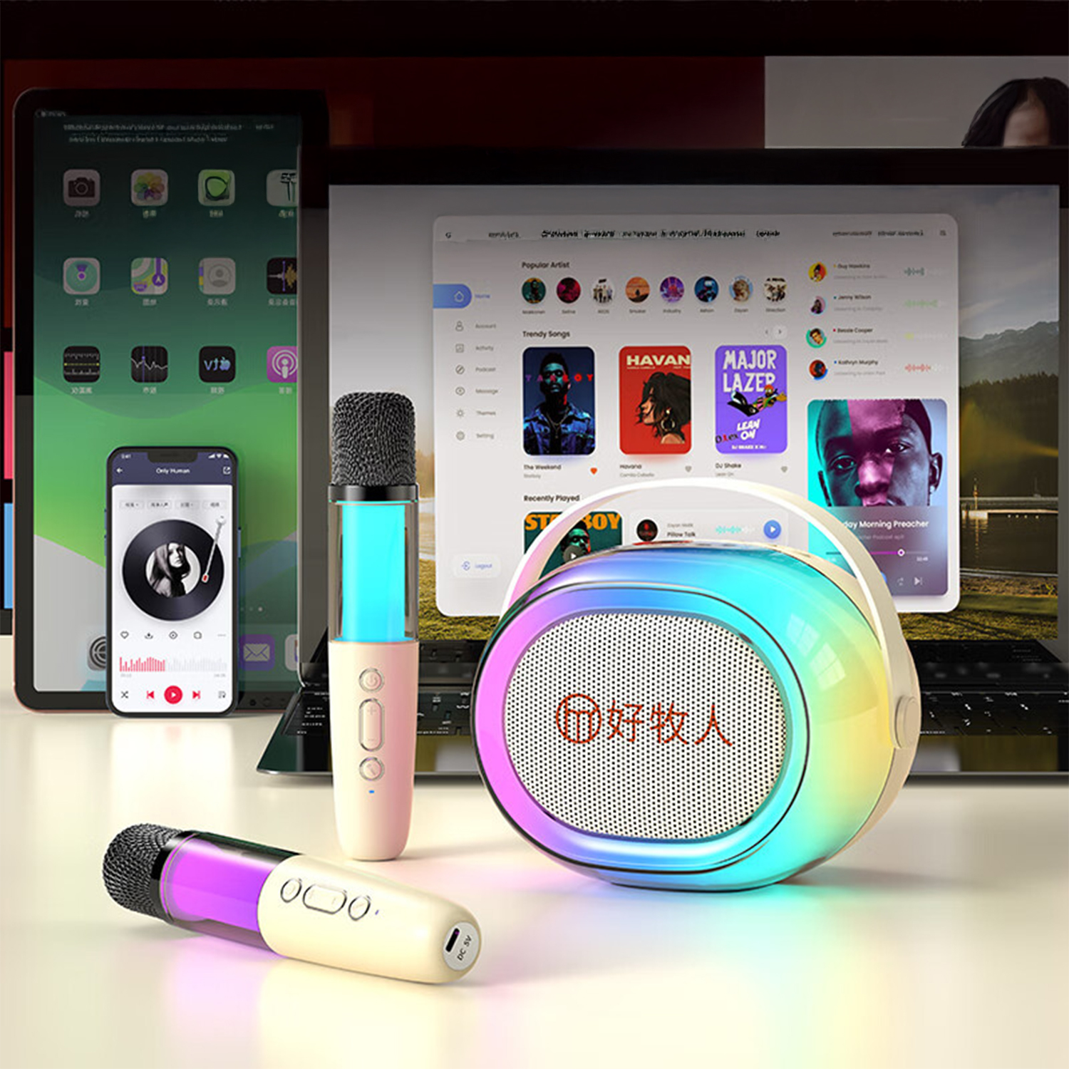Microfoni e altoparlante colorato davanti a laptop e telefoni.