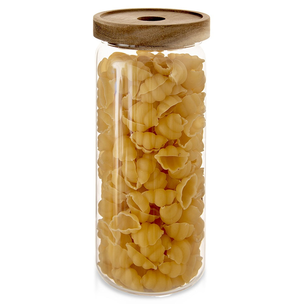 Un frasco de vidrio lleno de pasta amarillo pálido, cerrado con tapa de madera.