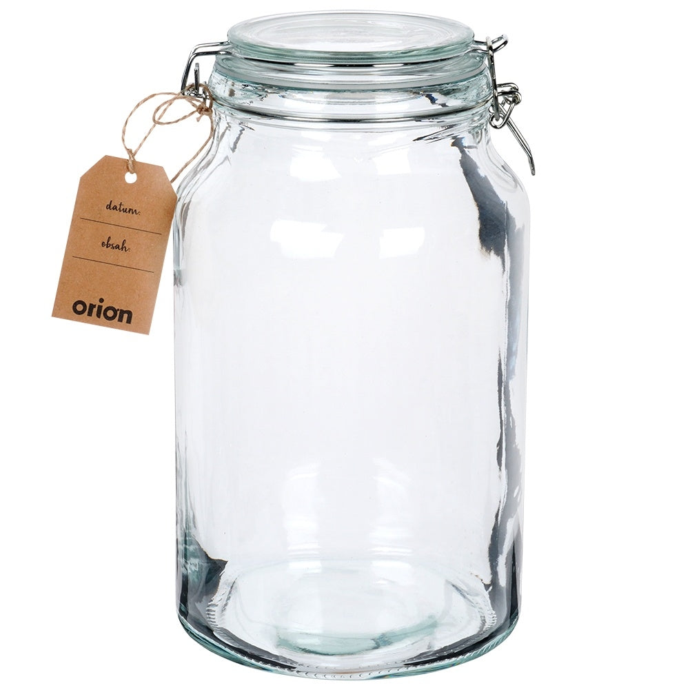 Un tarro de cristal transparente y vacío con tapa de clip y etiqueta marrón.