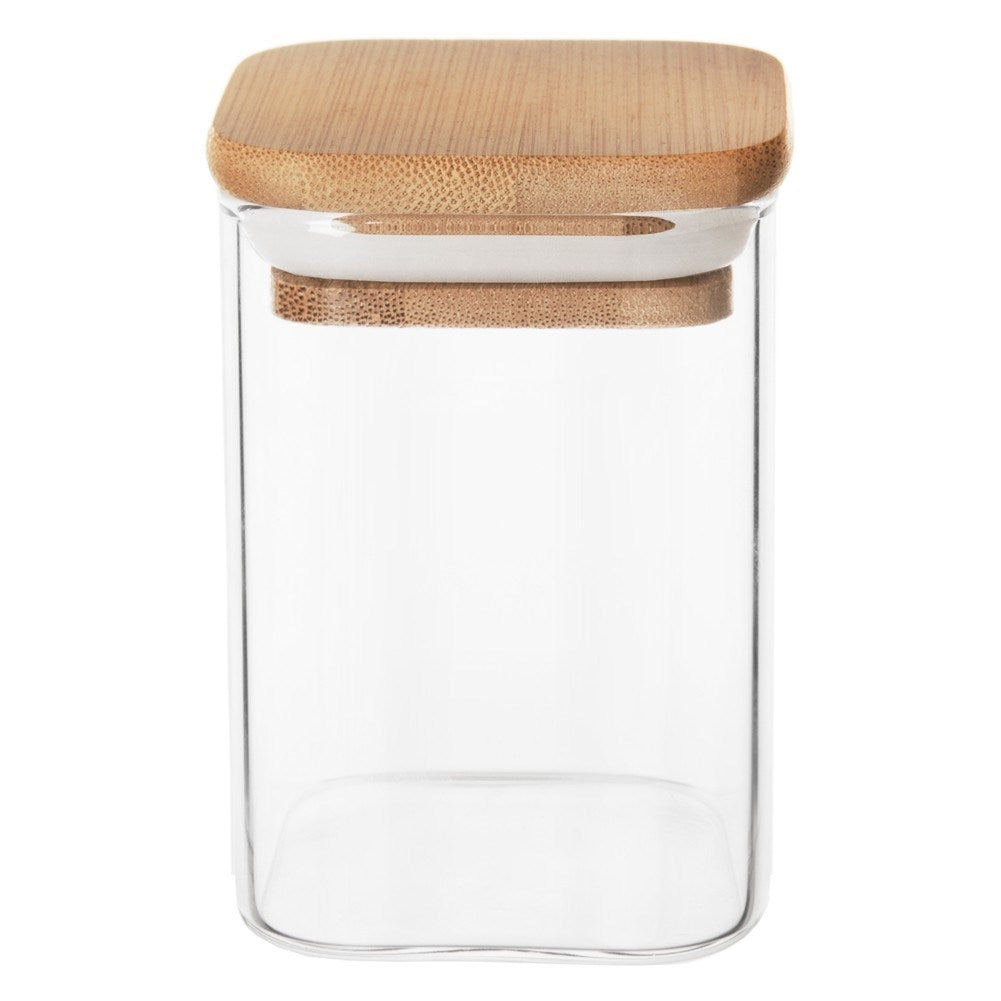 Un recipiente de vidrio transparente con tapa cuadrada de bambú y un anillo blanco.