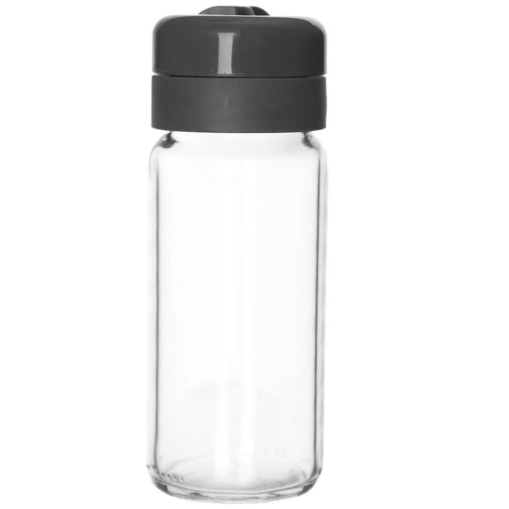Una botella de vidrio transparente y vacía con tapa gris.