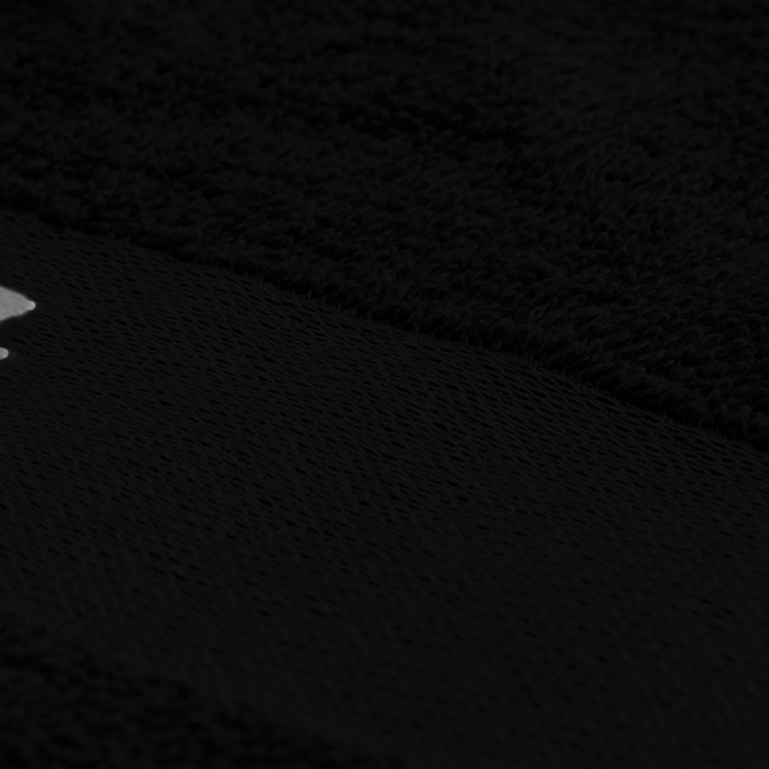 Nahaufnahme eines schwarzen, weichen Materials mit einer leichten Textur.