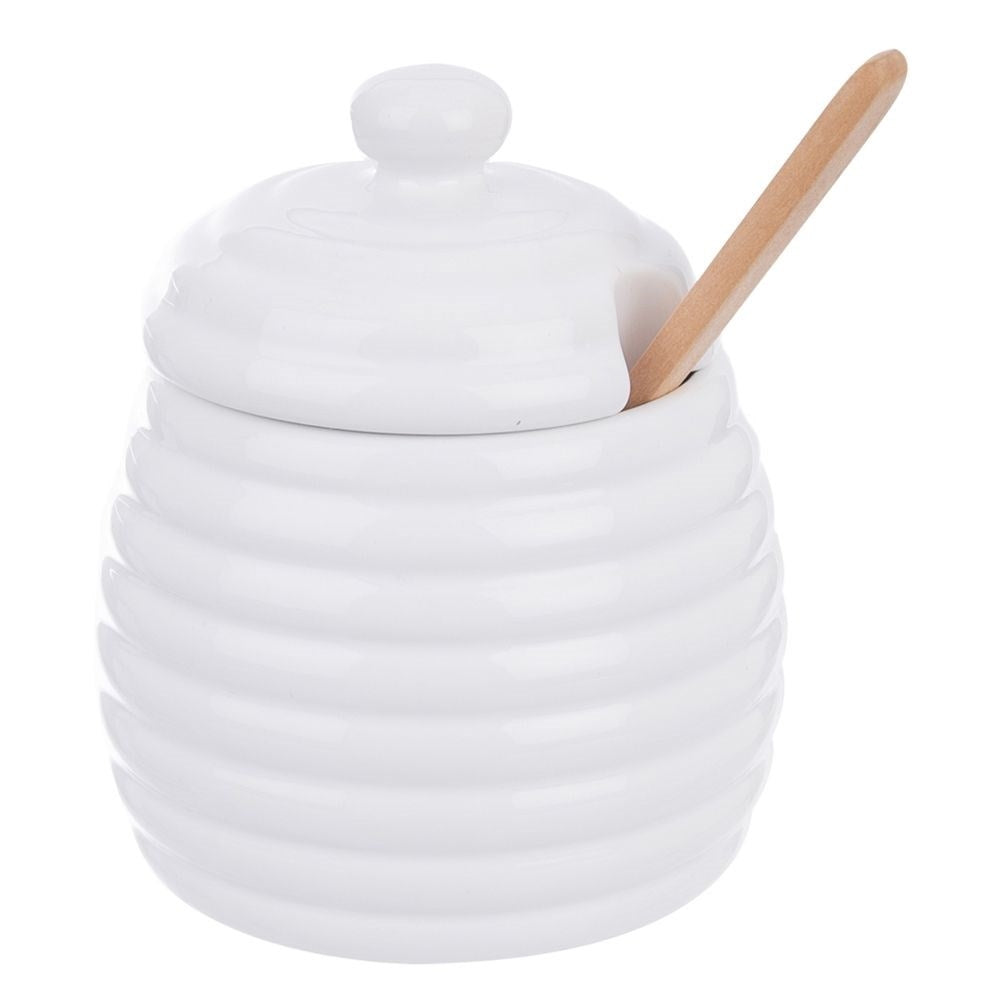 Olla de miel de cerámica blanca con tapa y cuchara de madera, diseño texturizado panal.
