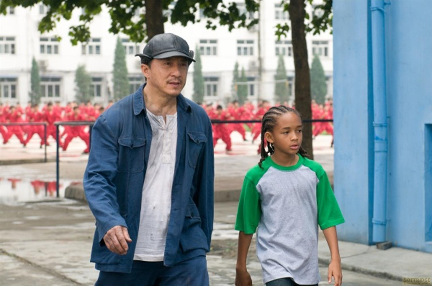 Jackie Chan et Jaden Smith passent devant un groupe en rouge.