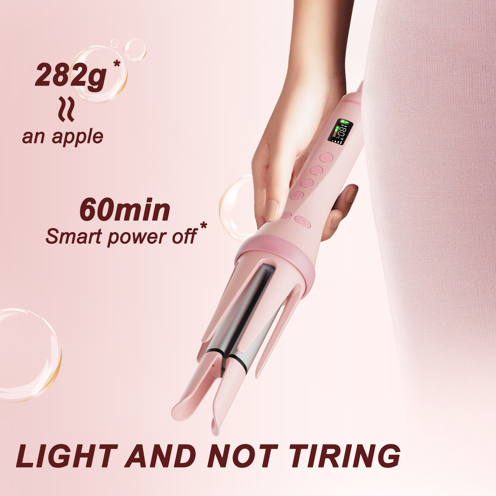 Eine Hand hält einen rosa Lockenstab mit einem Display. 282g, 60 Min. Smart Power Off.