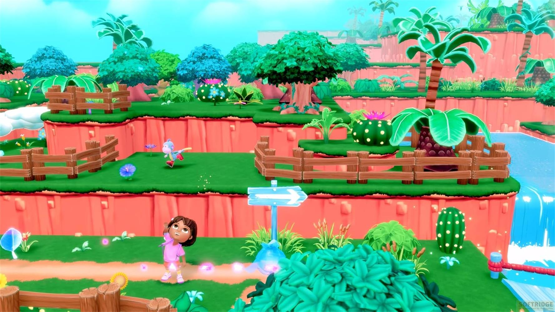 Dora et Boots dans un paysage coloré et cartoon avec cascades et cactus.
