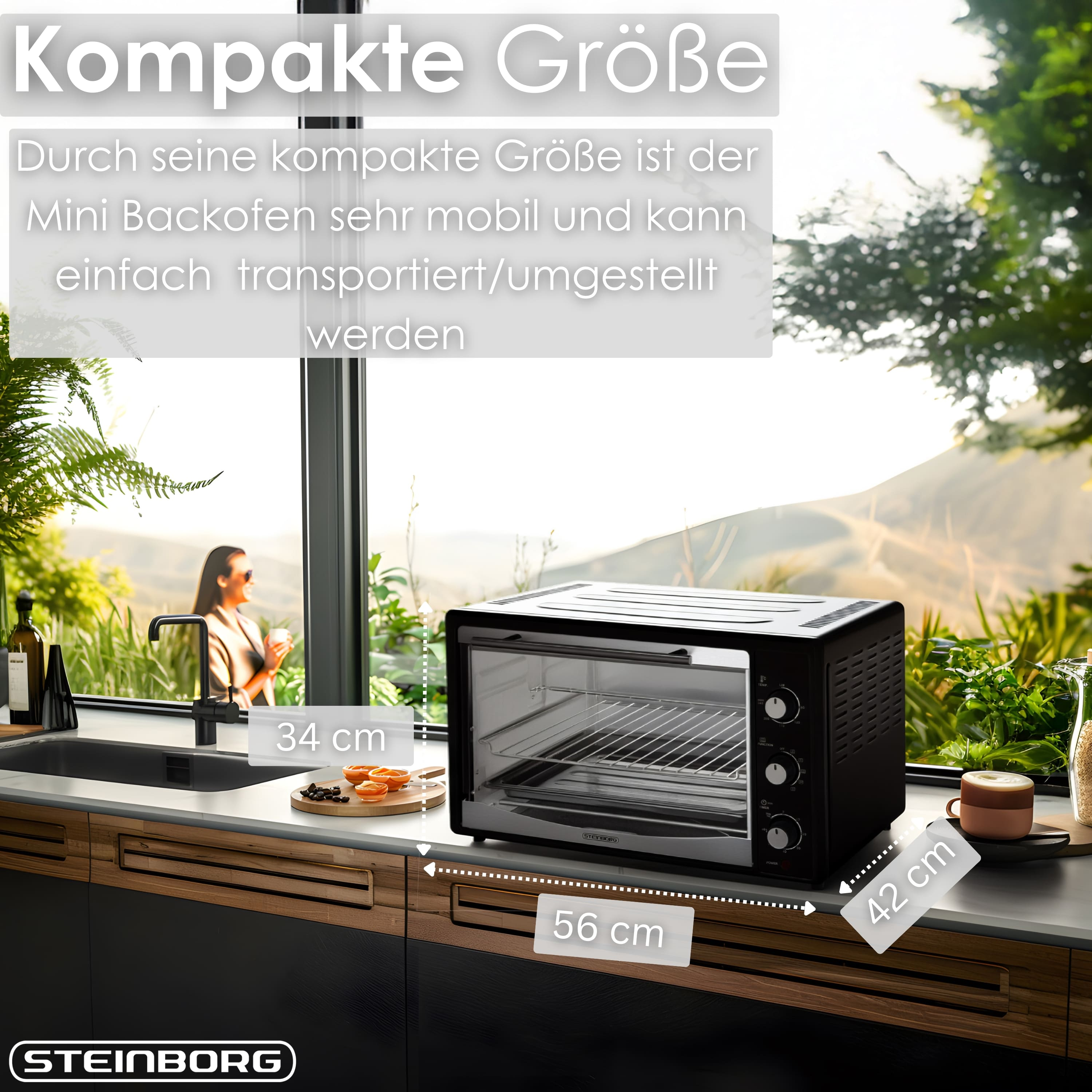 Ein kompakter schwarzer Mini-Backofen steht auf einer Arbeitsplatte neben einem Waschbecken.