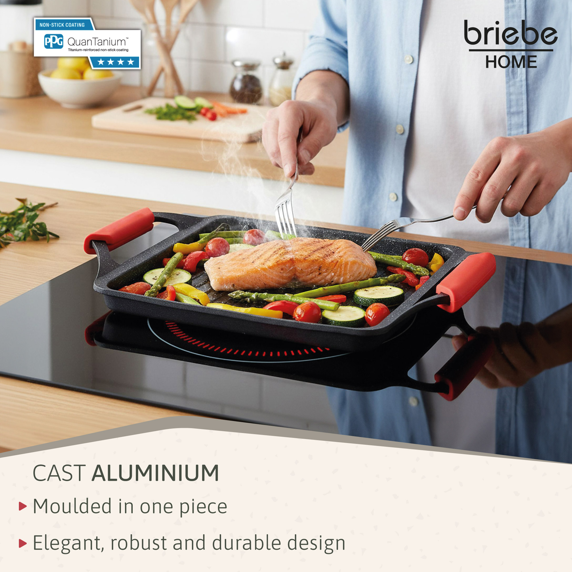 Una persona asa salmón y verduras en una sartén de aluminio fundido en una estufa de inducción.