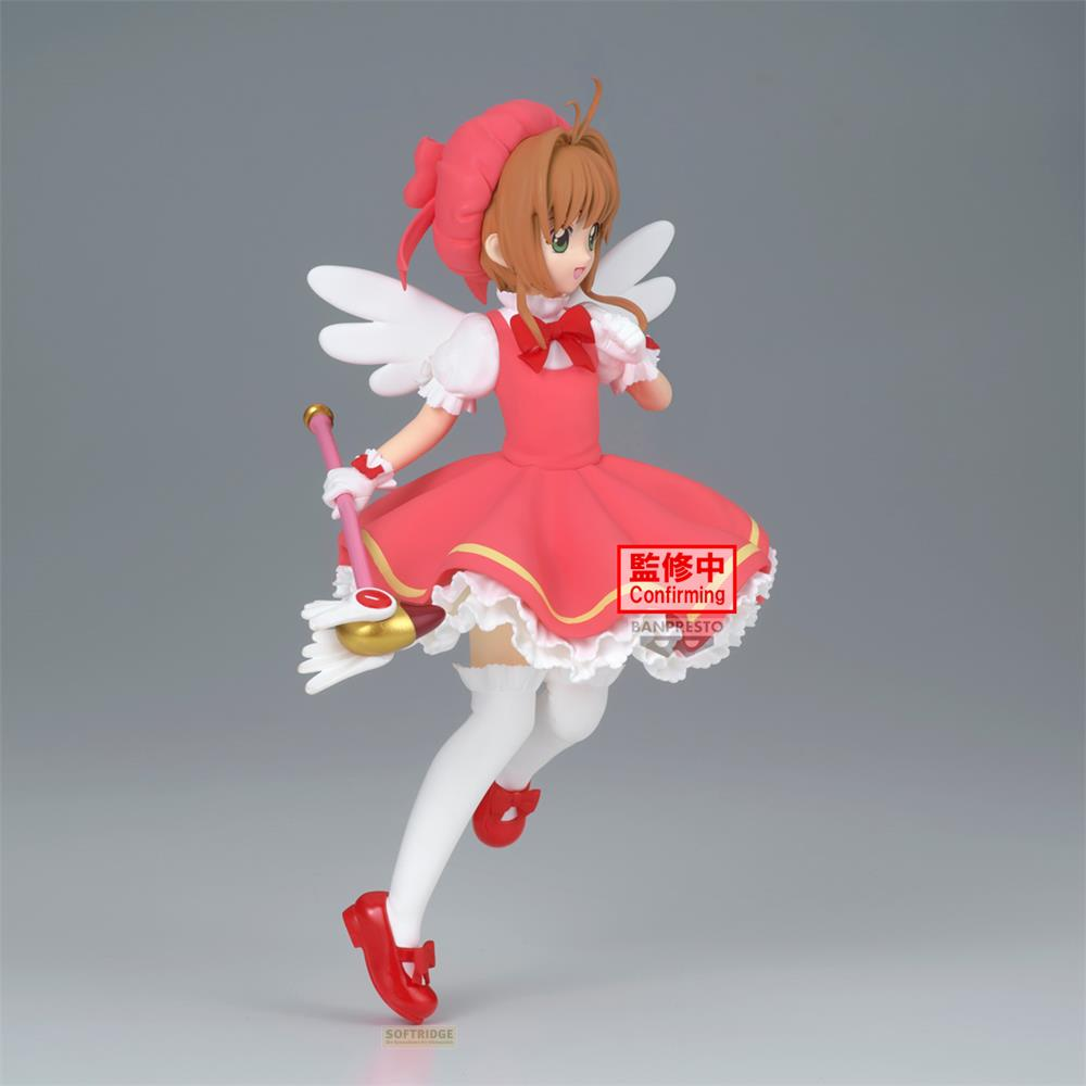 Una figura de anime con vestido rosa, alas blancas y varita mágica.