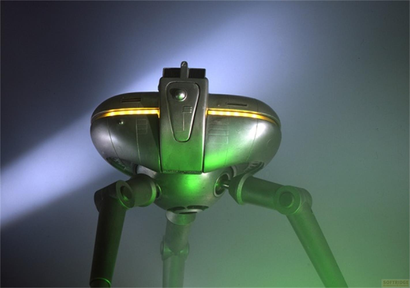Un robot futuristico a tre gambe con illuminazione verde e accenti gialli.