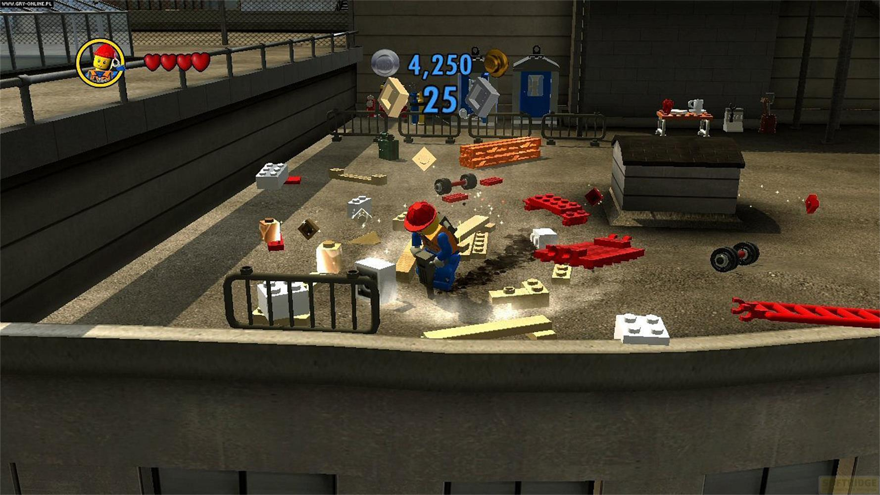 Un personnage Lego utilise un marteau-piqueur sur un chantier jonché de briques Lego.