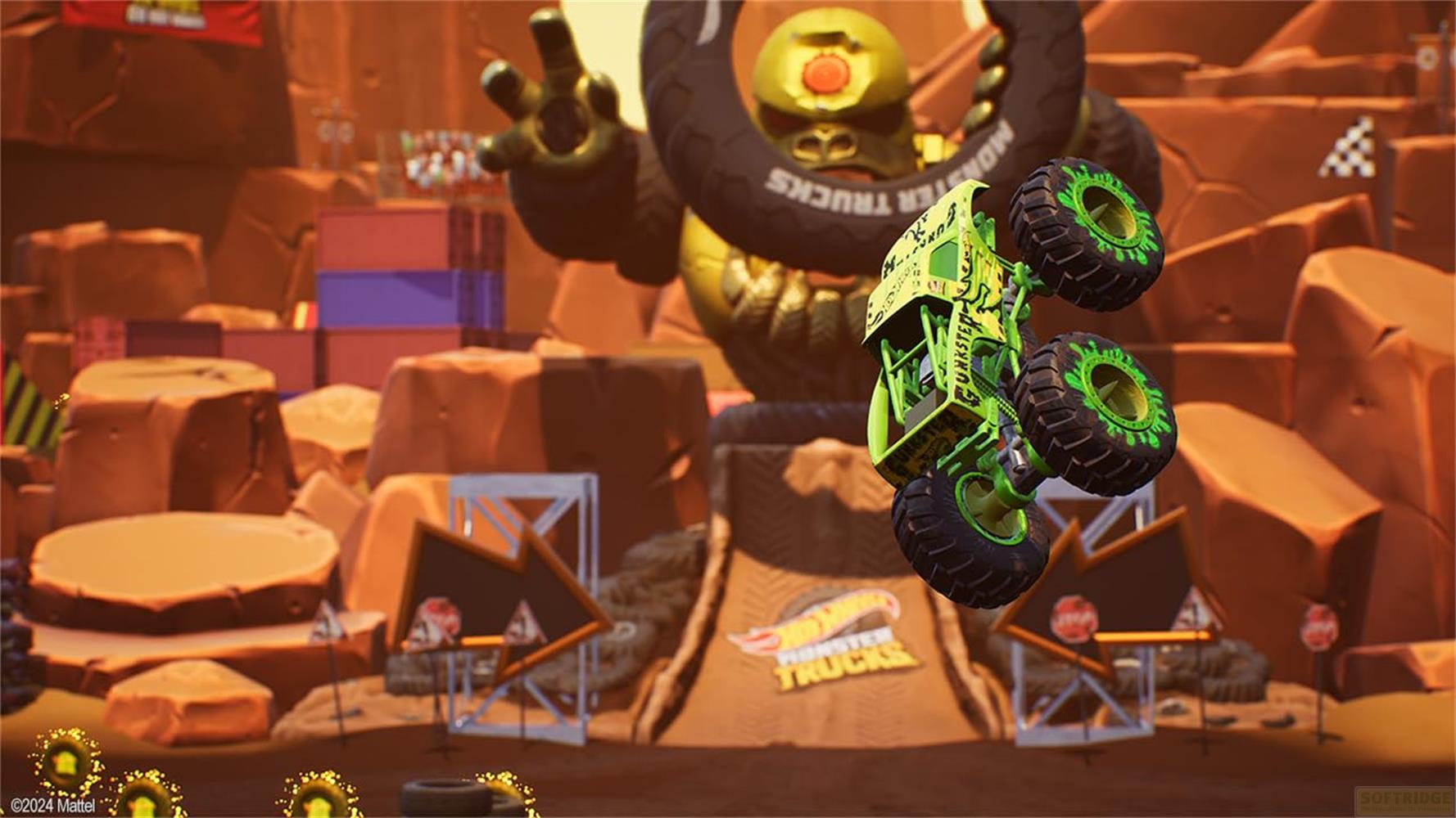 Ein grüner Monstertruck fliegt durch die Luft vor einer goldenen Figur.