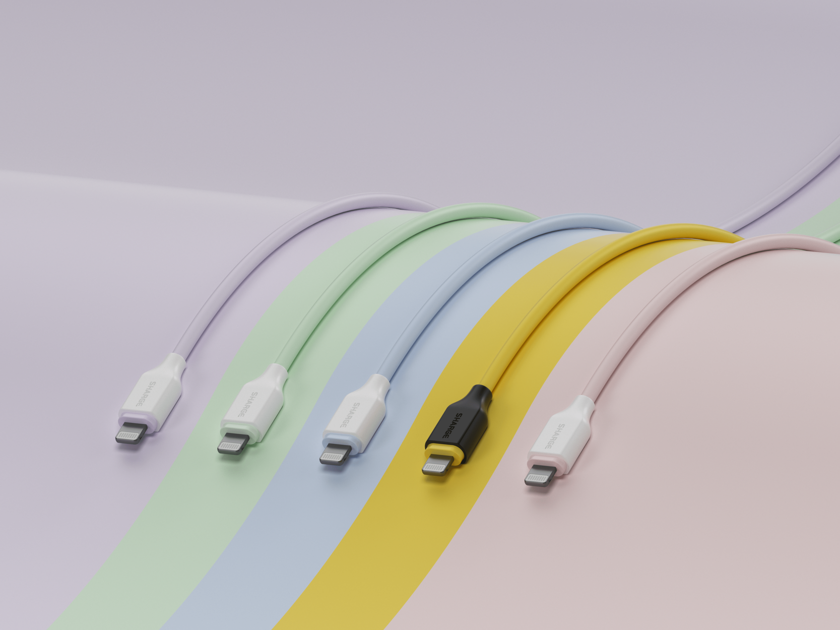 Cinq câbles de chargement colorés aux tons pastel reposent sur des couleurs pastel.