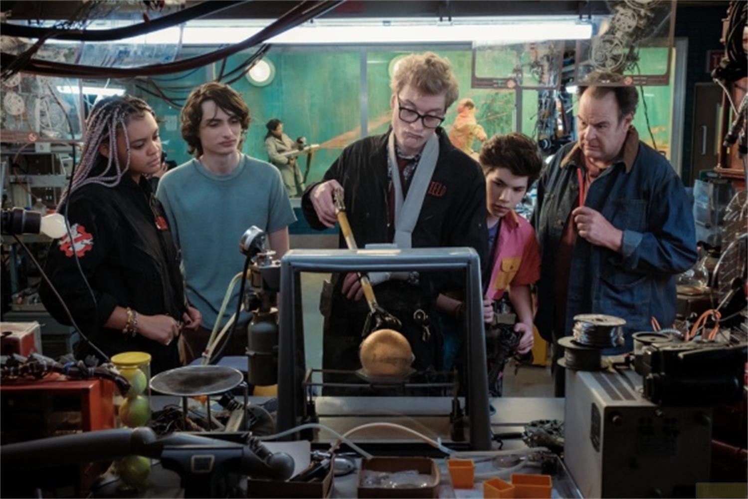 Un gruppo di persone in un laboratorio guarda un dispositivo con una sfera dorata all'interno.