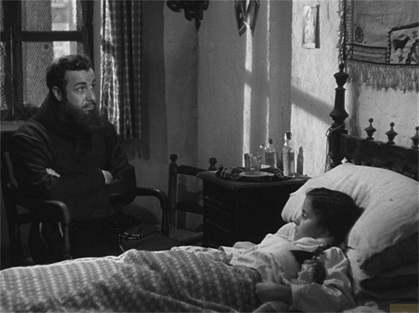 Un uomo con la barba siede accanto a un bambino malato a letto.