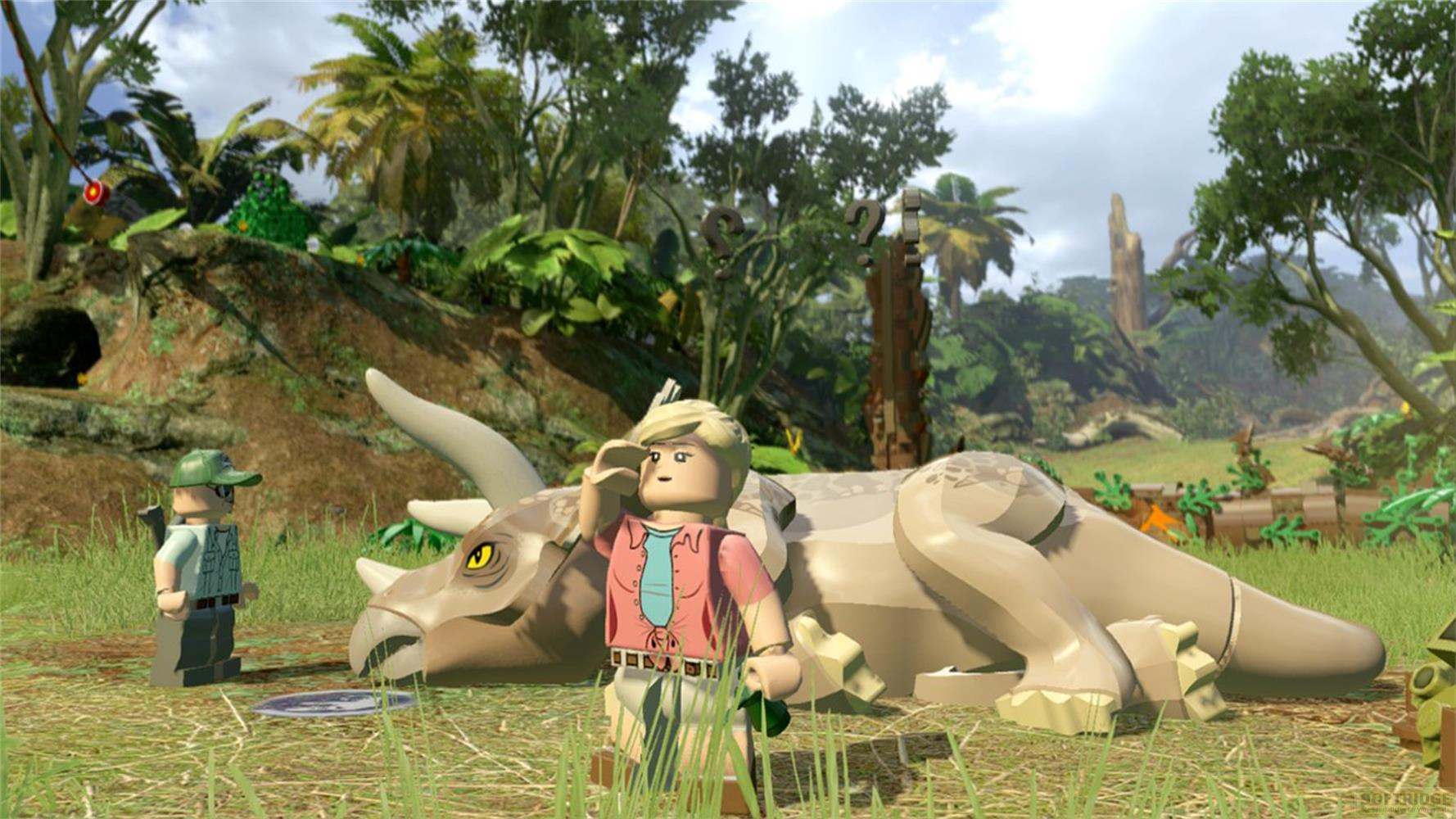 Zwei Lego-Figuren stehen neben einem liegenden Triceratops im Dschungel.
