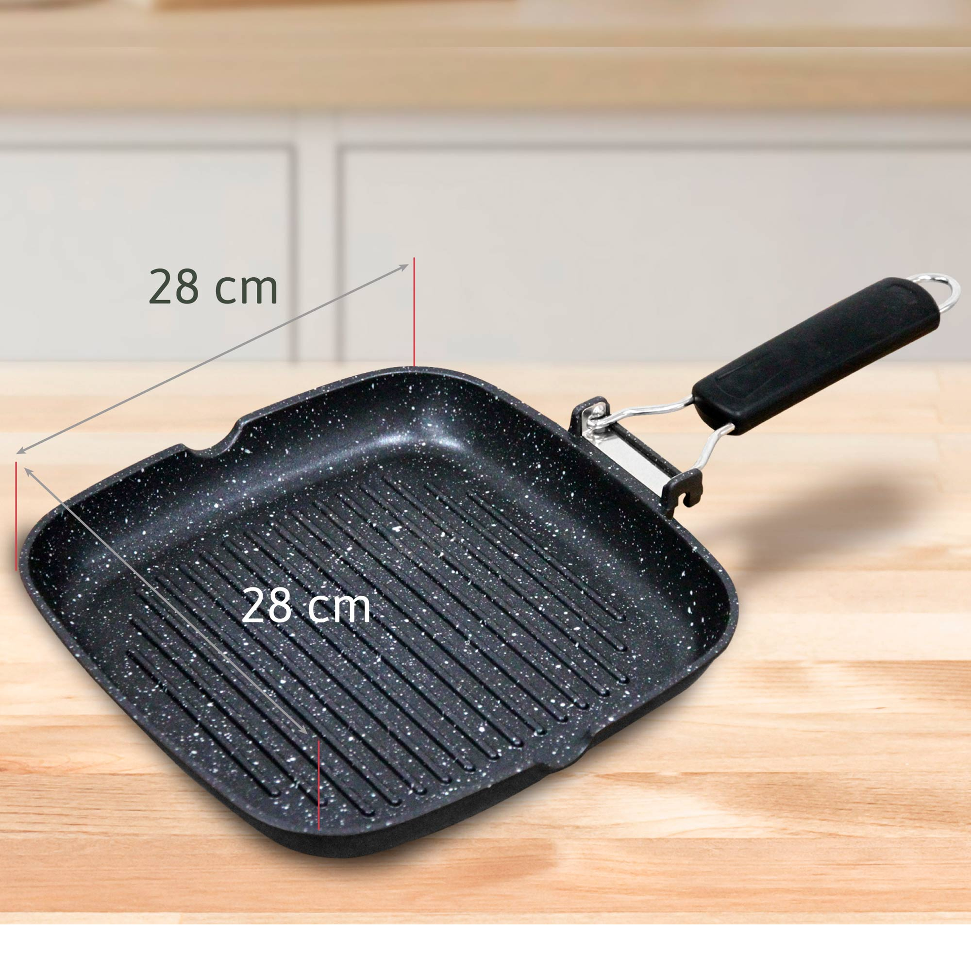 Una sartén grill rectangular de 28 cm con mango negro sobre mesa de madera.