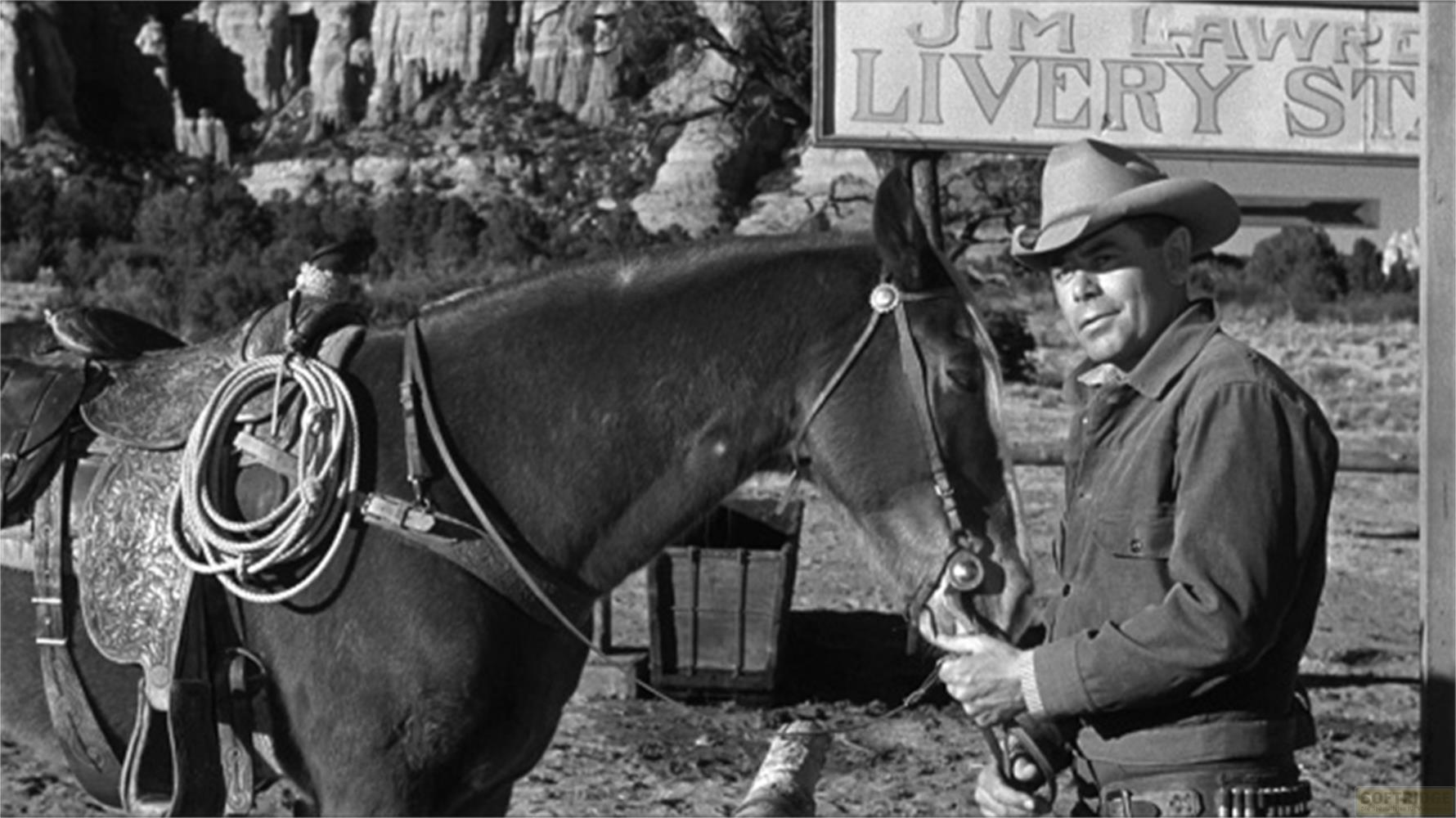 Ein Cowboy steht neben einem Pferd vor einem Schild mit der Aufschrift "Jim Lawrence Livery St.