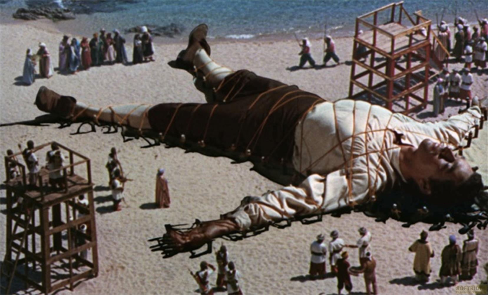 Un homme géant gisait ligoté sur une plage, entouré de plus petites personnes.
