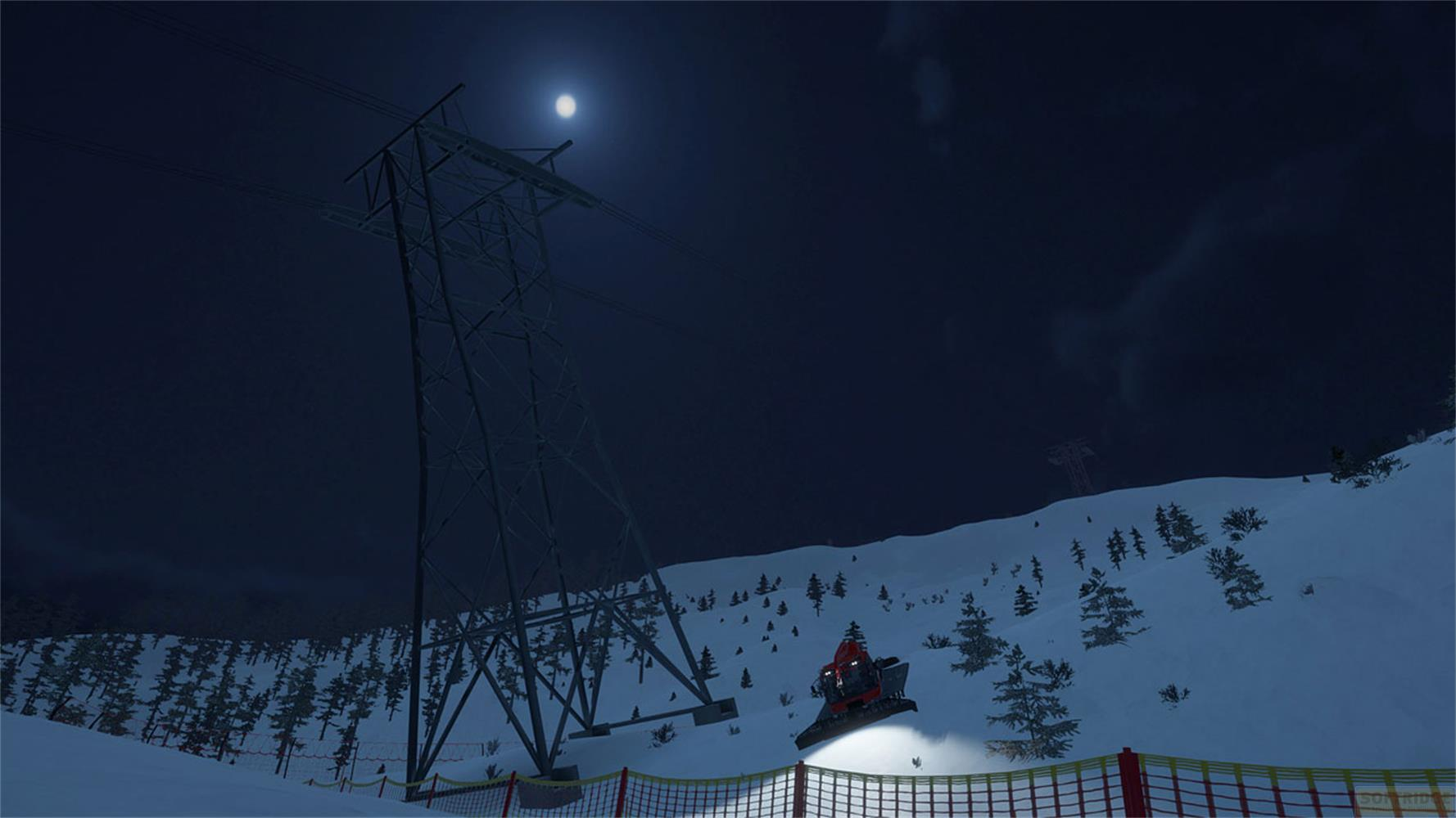 Rastrello da neve salta di notte davanti a un traliccio su un pendio innevato.