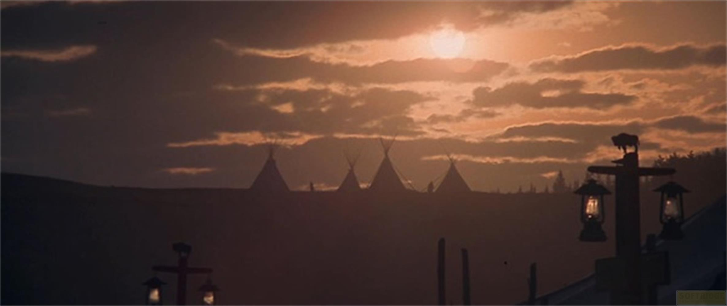 Tramonto su teepee con un bisonte su un palo.