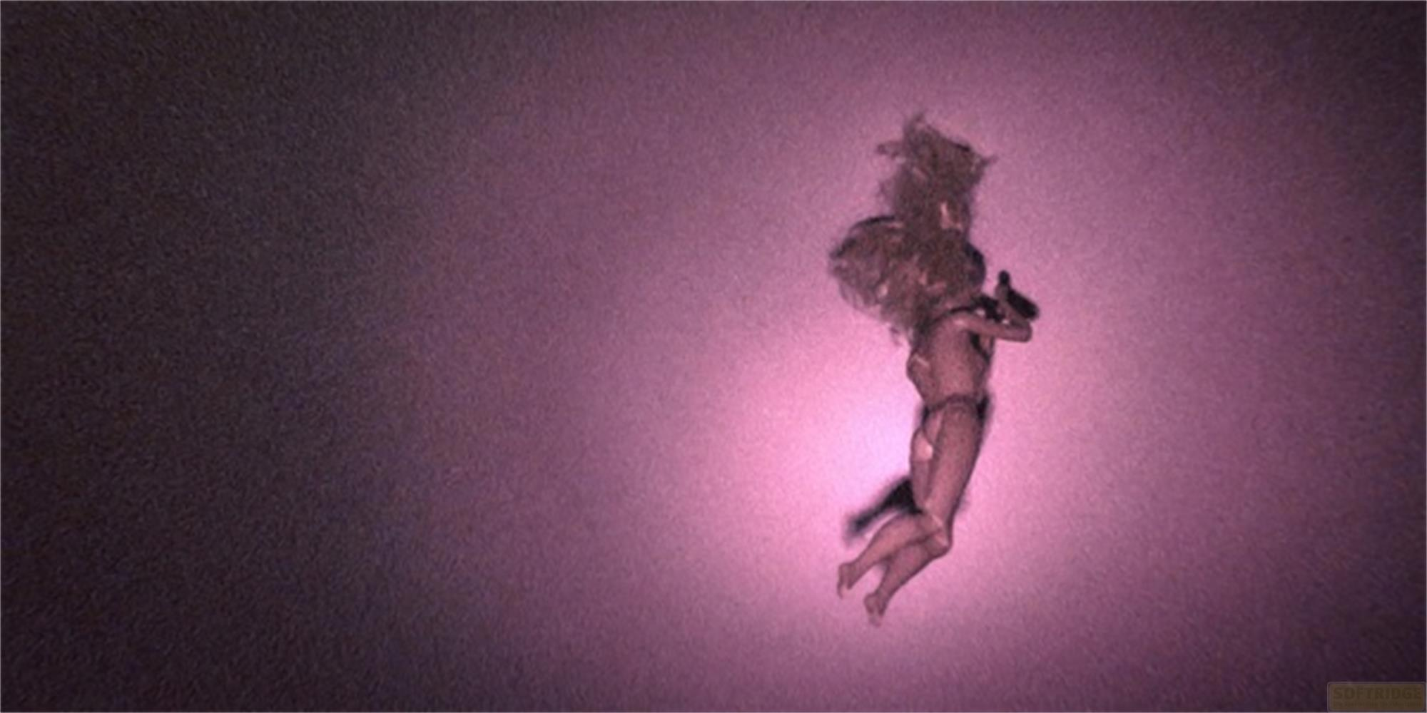 Una bambola galleggia nello spazio viola, con capelli biondi e bikini.