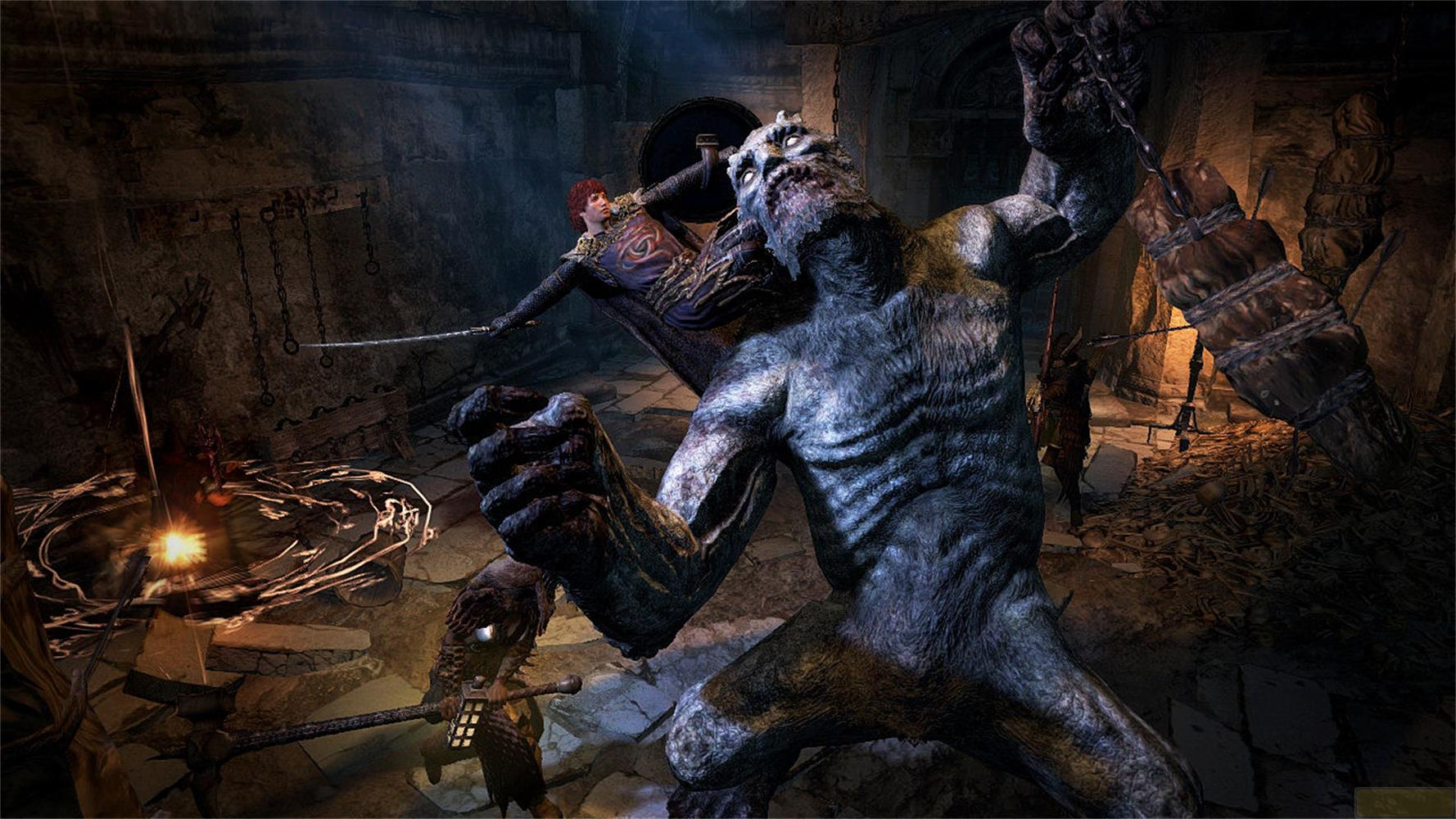 Ein Monster kämpft gegen einen Krieger in einer dunklen Höhle voller Knochen.