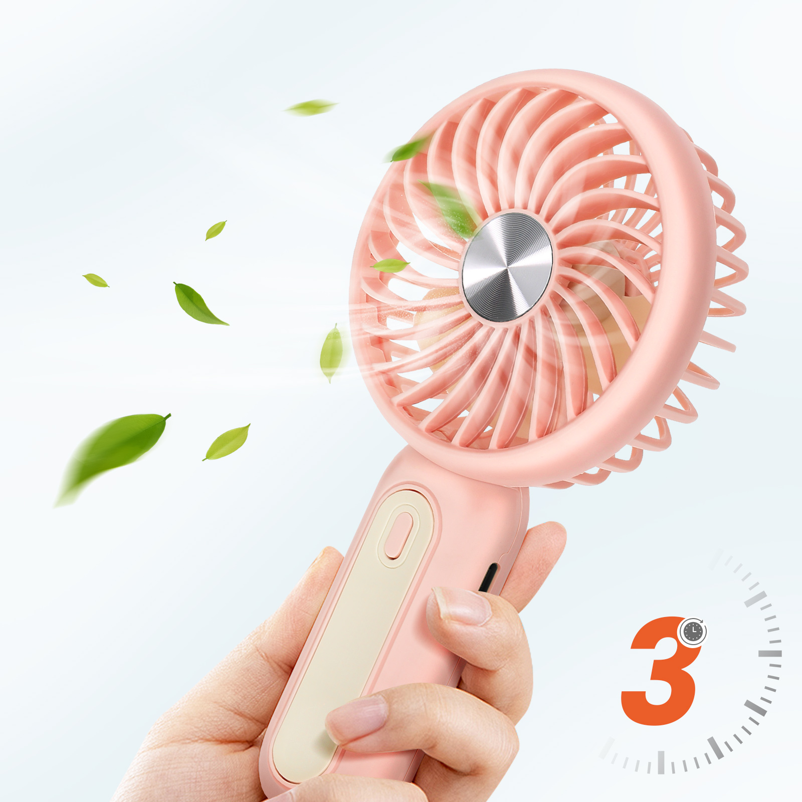 Eine Hand hält einen rosafarbenen Ventilator mit sich drehenden Blättern. Grüne Blätter schweben.