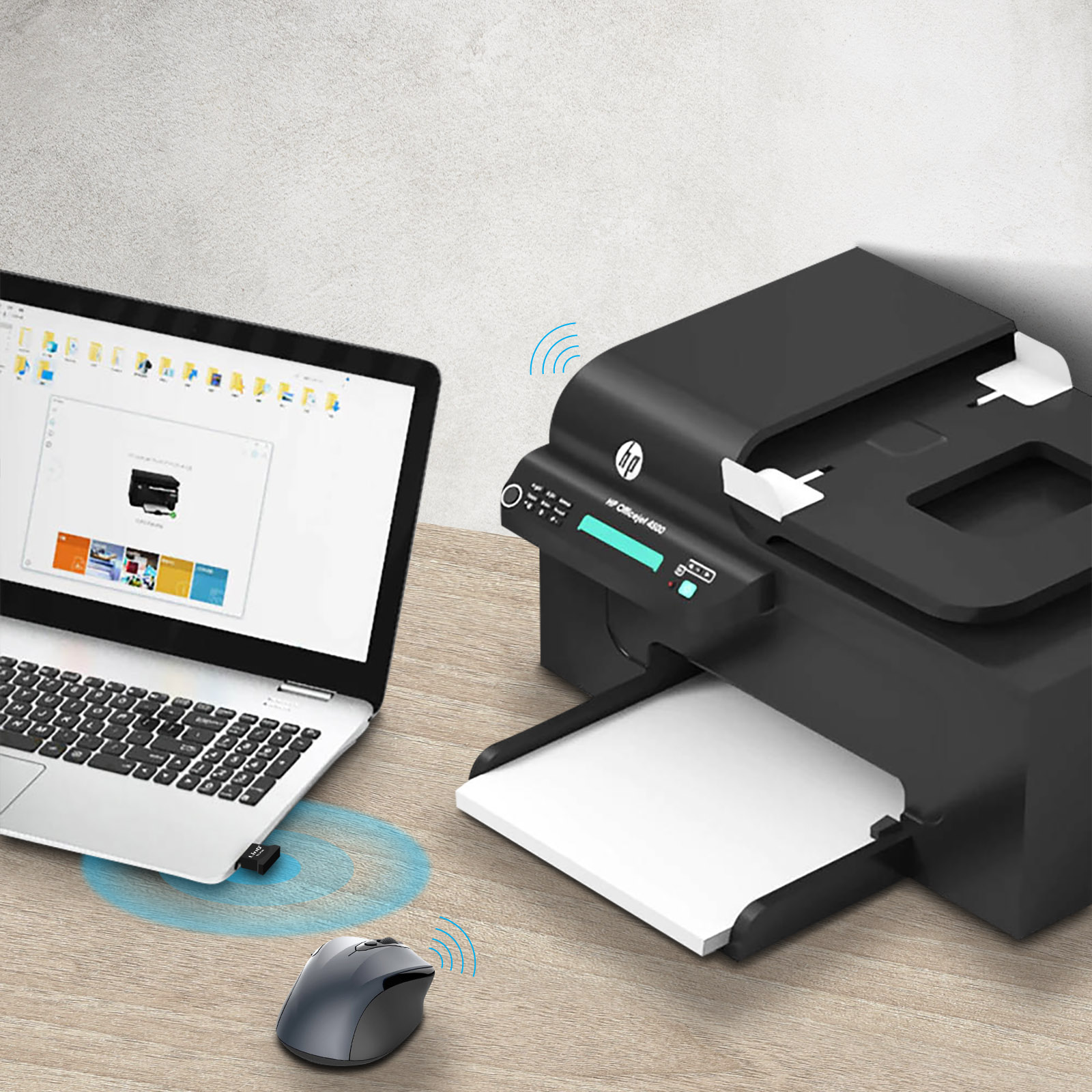 Un portátil con dongle USB, un ratón y una impresora sobre una mesa de madera.