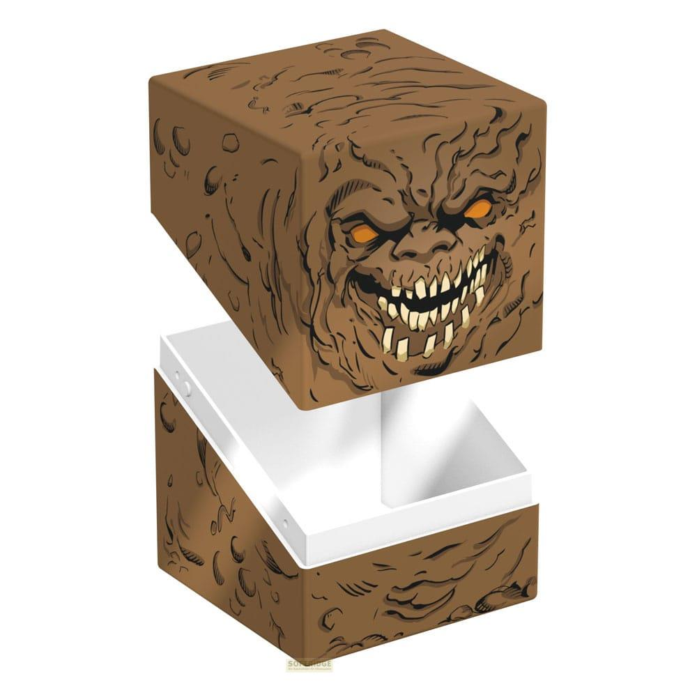 Ein brauner Würfel mit einem Monstergesicht, der Deckel ist offen.