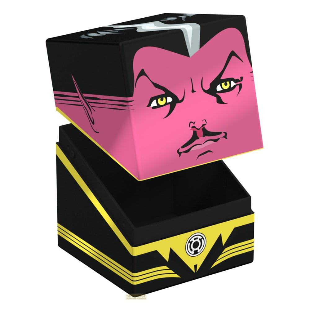 Eine schwarze Box mit pinkem Gesicht und gelber Verkleidung, offen und mit schwarzem Inneren.