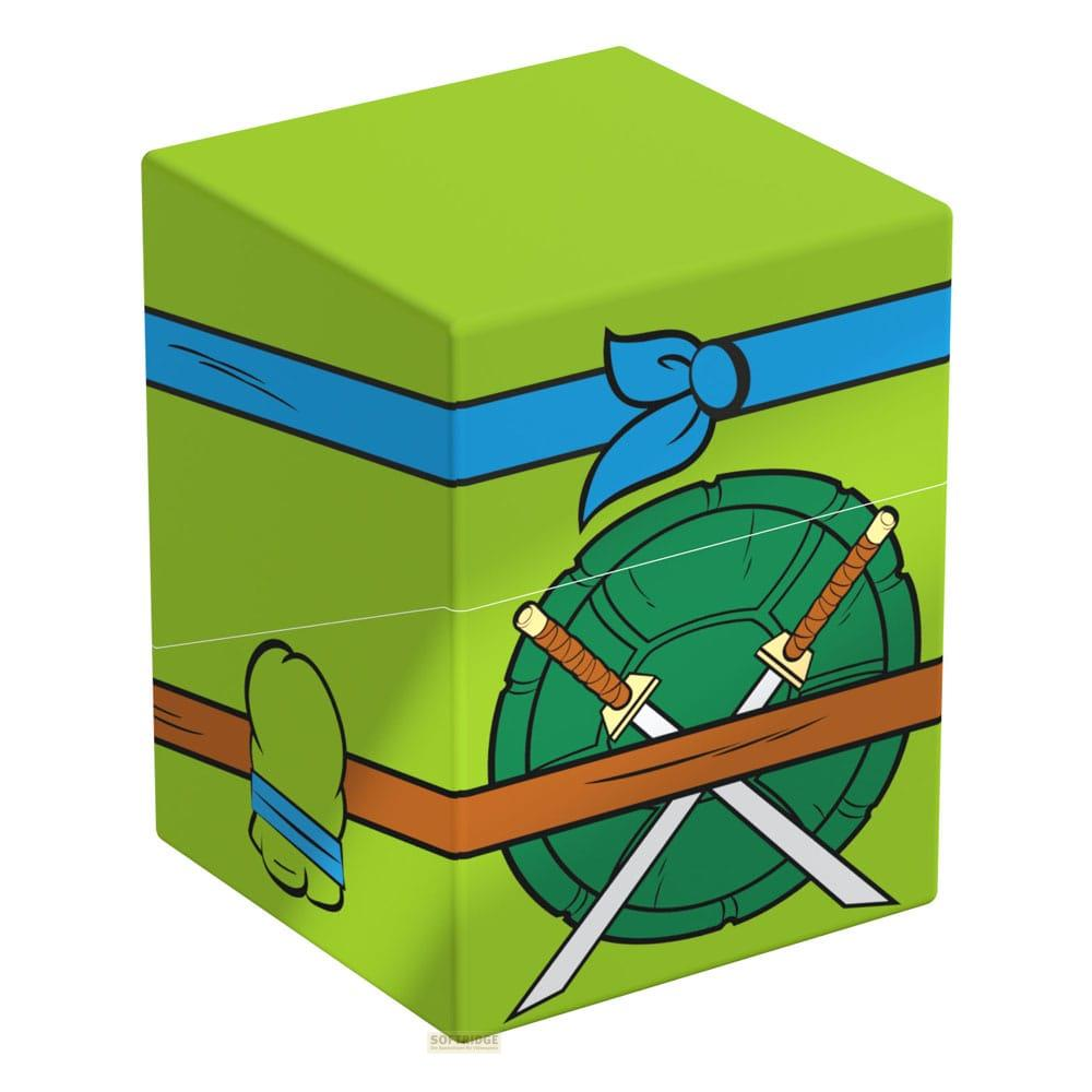 Boîte verte avec motif de carapace de tortue, bande bleue et épées croisées.
