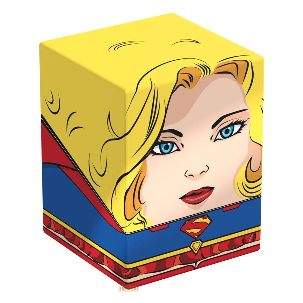 Cubo giallo con volto di Supergirl, costume blu e rosso, logo scudo a S.