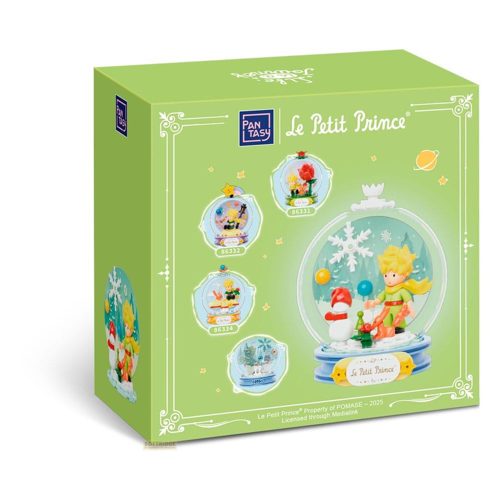 Grüne Box mit Le Petit Prince-Motiv, Schneekugeln und einer Schneekugel mit Figur.