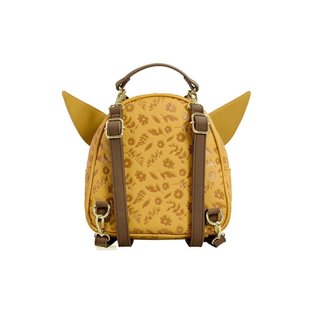 Una mochila amarilla con correas marrones y estampado floral. Tiene orejas.