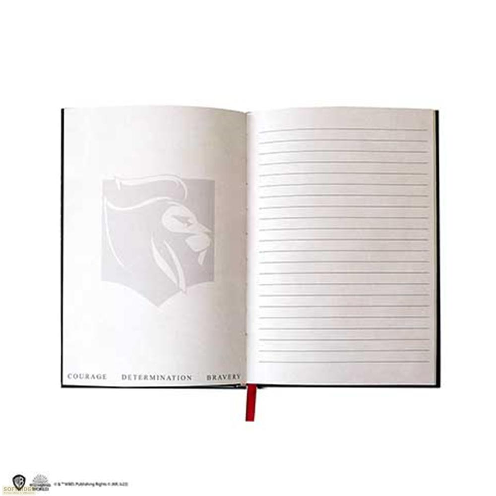 Ein offenes Notizbuch mit einem Löwenwappen auf der linken Seite und linierten Seiten rechts.