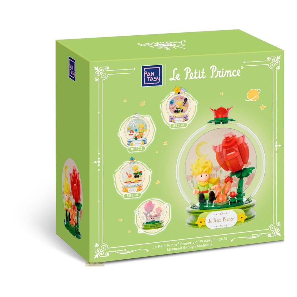 Grüne Box mit Le Petit Prince Motiven und Schneekugeln mit Szenen.