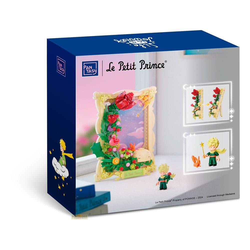 Verpackung des Le Petit Prince Bausatzes mit Blumenrahmen, Figuren und Sternen.