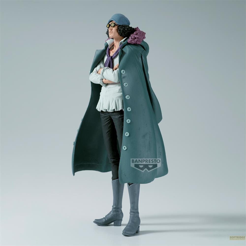 Figura con boina azul, gafas, bufanda morada, capa turquesa, camisa blanca y pantalones negros.
