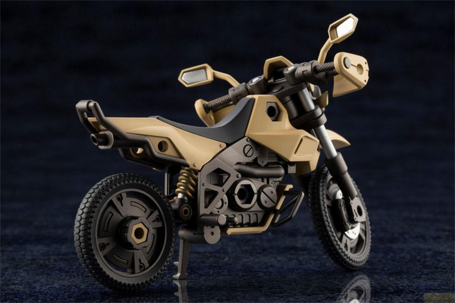 Une moto modèle beige avec des pneus noirs et des détails.