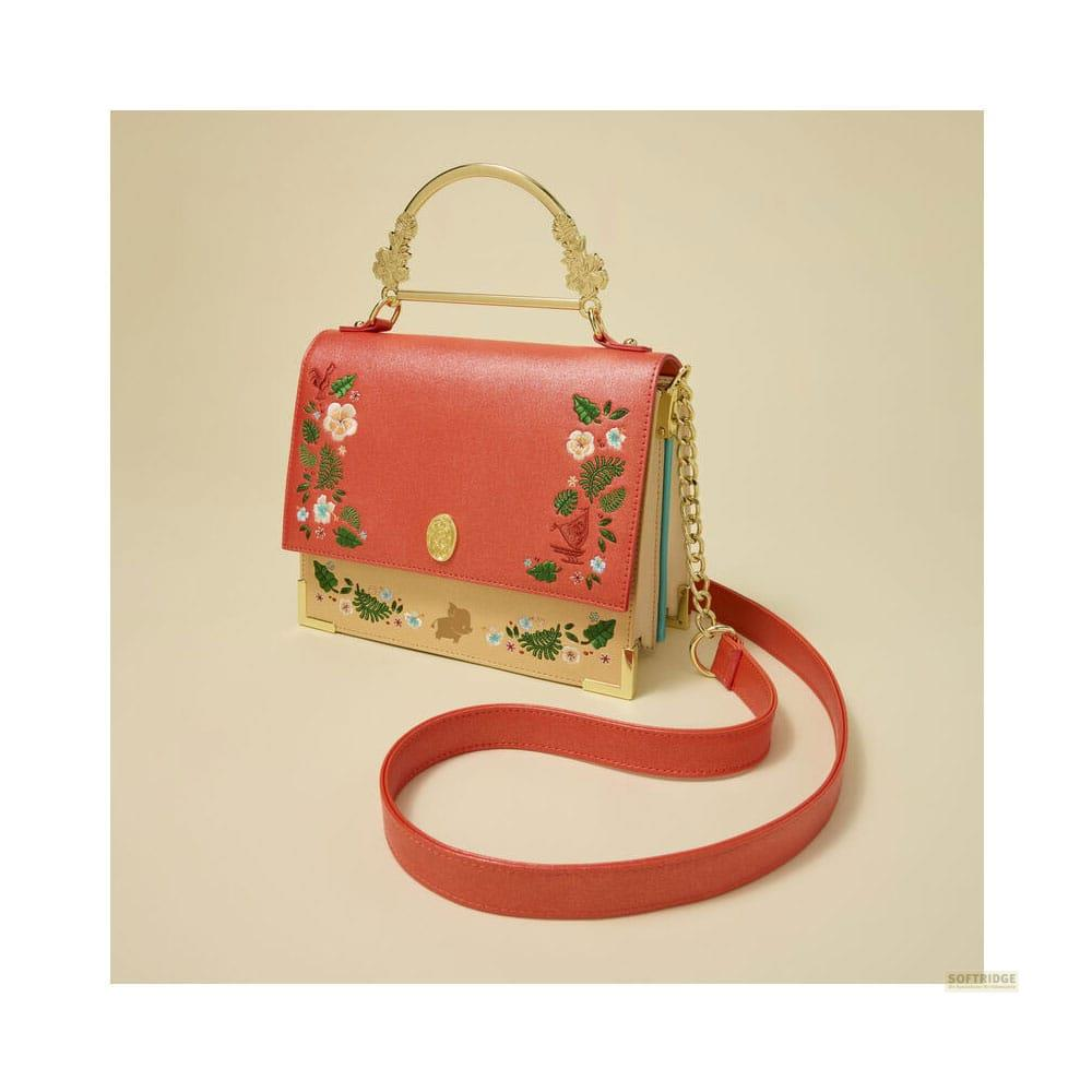 Bolso rojo con bordado floral y asa dorada sobre fondo beige.