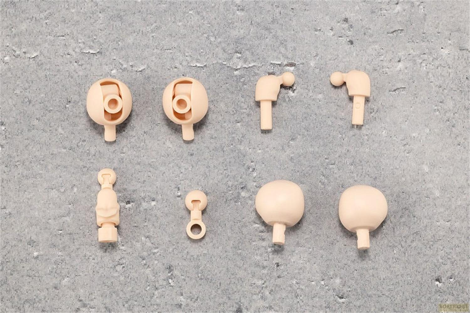 Pièces de maquette beige : douilles d'articulation sphérique, un torse, un membre et des rotules.