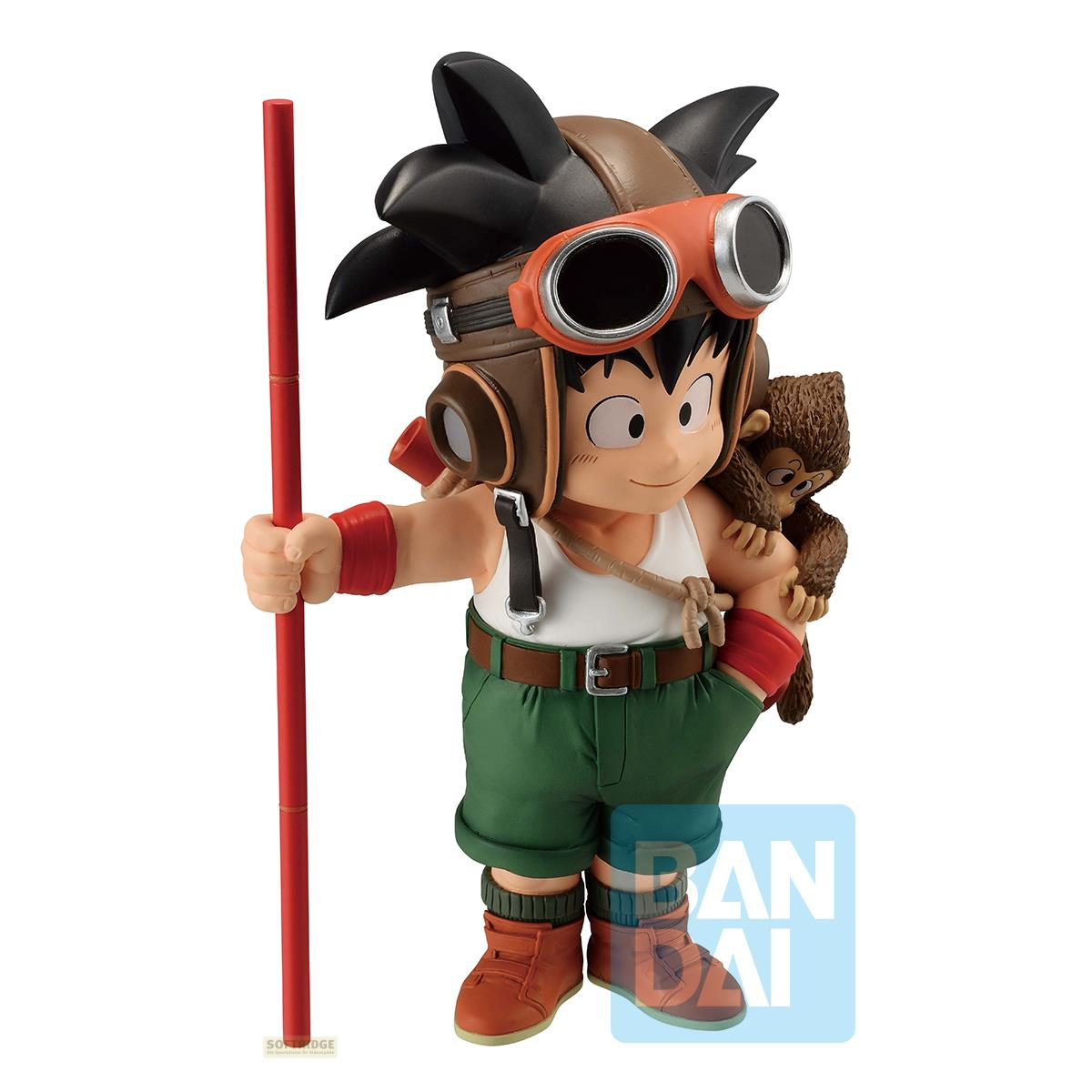 Figura del joven Goku con gafas, un bastón rojo y un pequeño mono en su hombro.