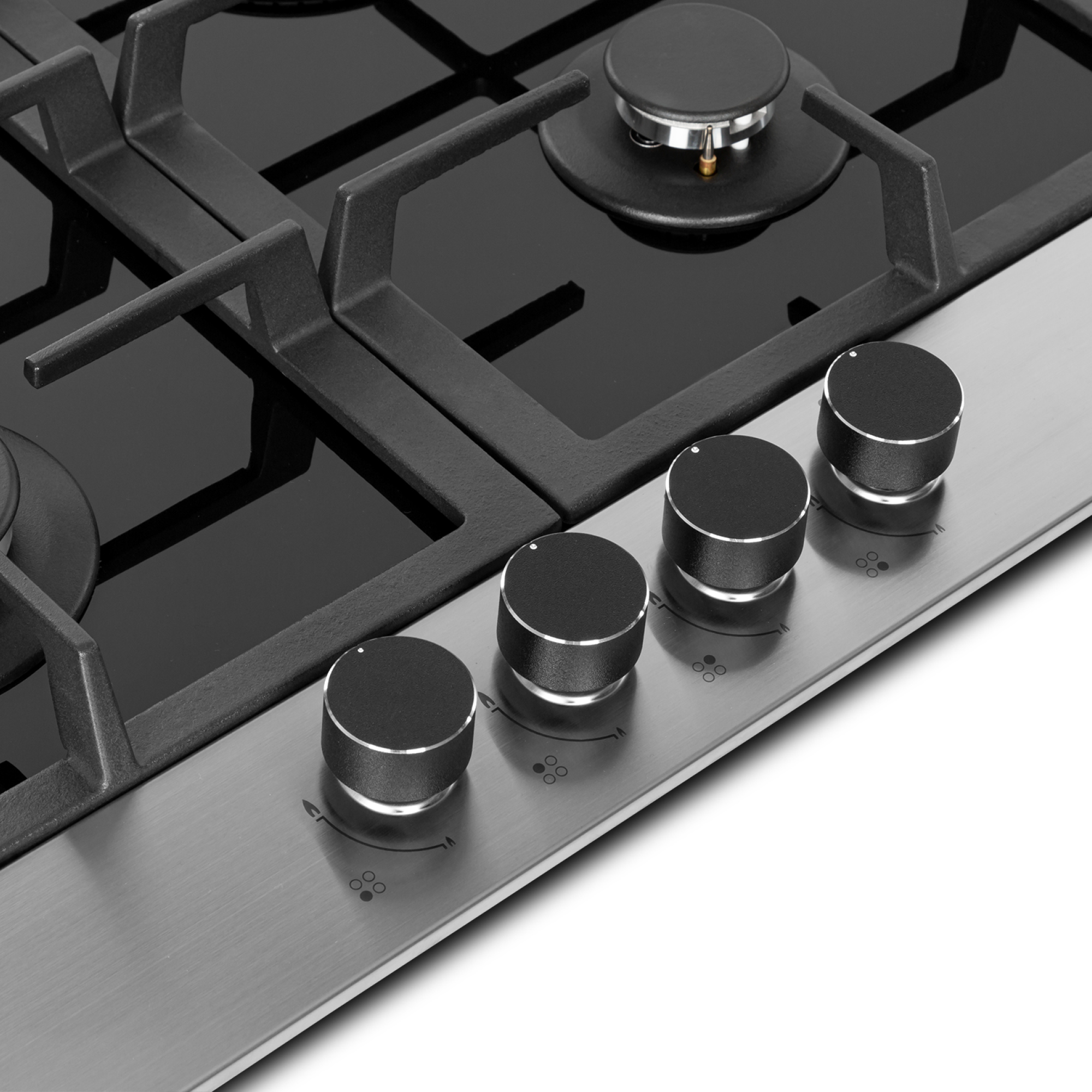 Primer plano de una cocina de gas con superficie de cristal negro y cuatro mandos.