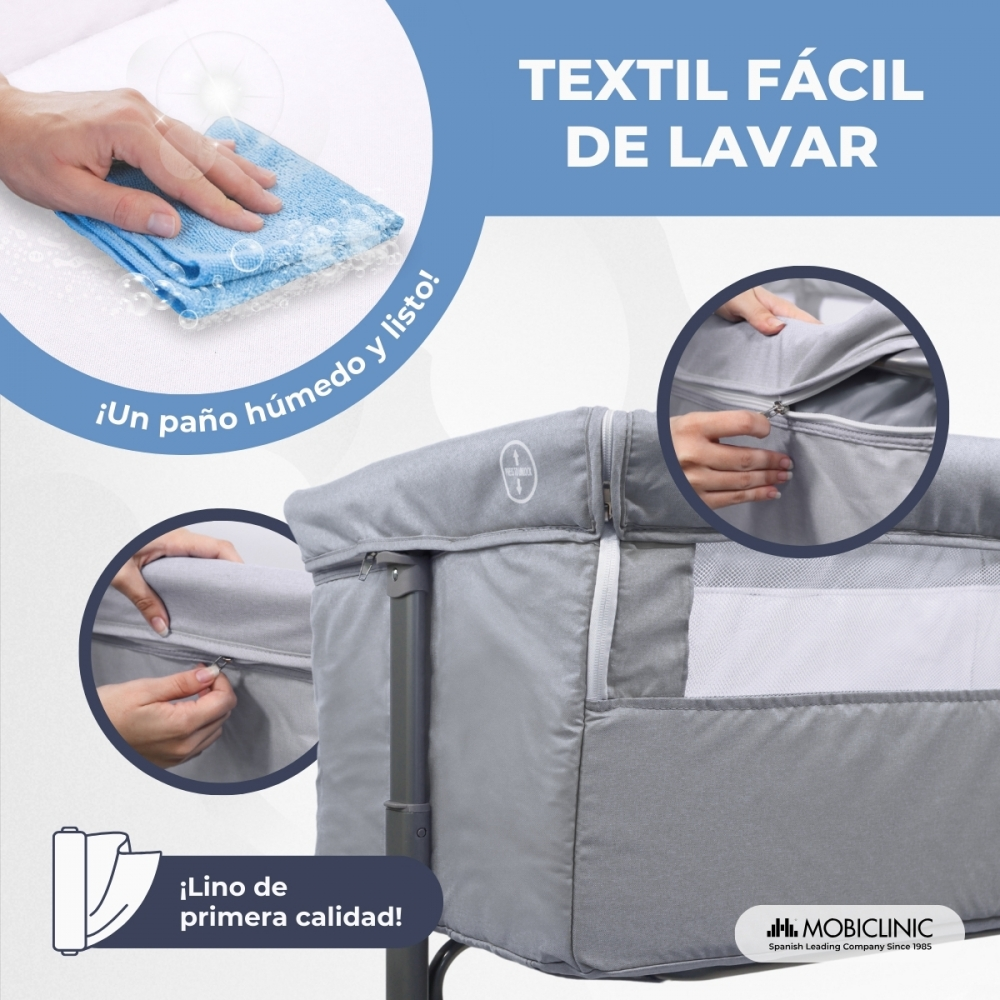 Cuna gris con cremallera, mostrando tejido fácil de lavar.