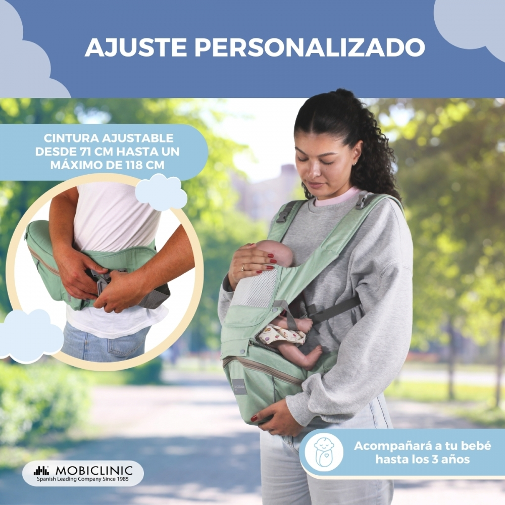 Una mujer lleva un bebé en un portabebés verde menta. Cintura ajustable.