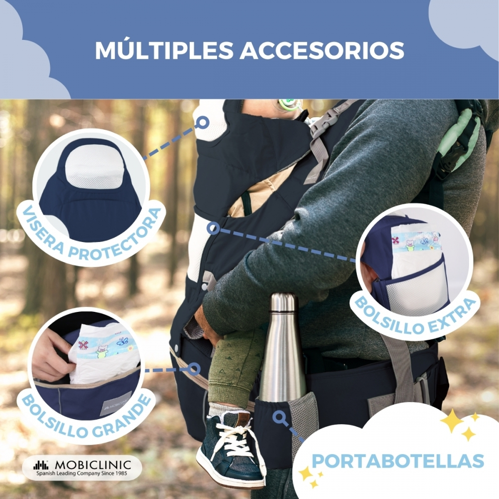 Un hombre lleva un bebé en un portabebés con accesorios: visera, bolsillo pañal, portabotellas.