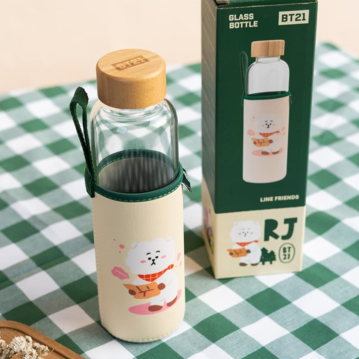 Una bottiglia di vetro con manica beige e un personaggio BT21.