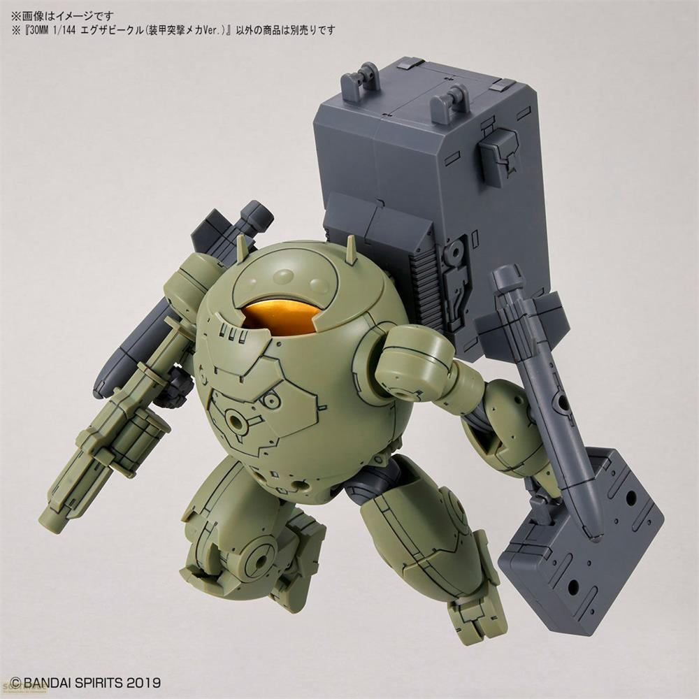 Ein grüner, kugelförmiger Mech mit einem großen grauen Rucksack und Waffen.