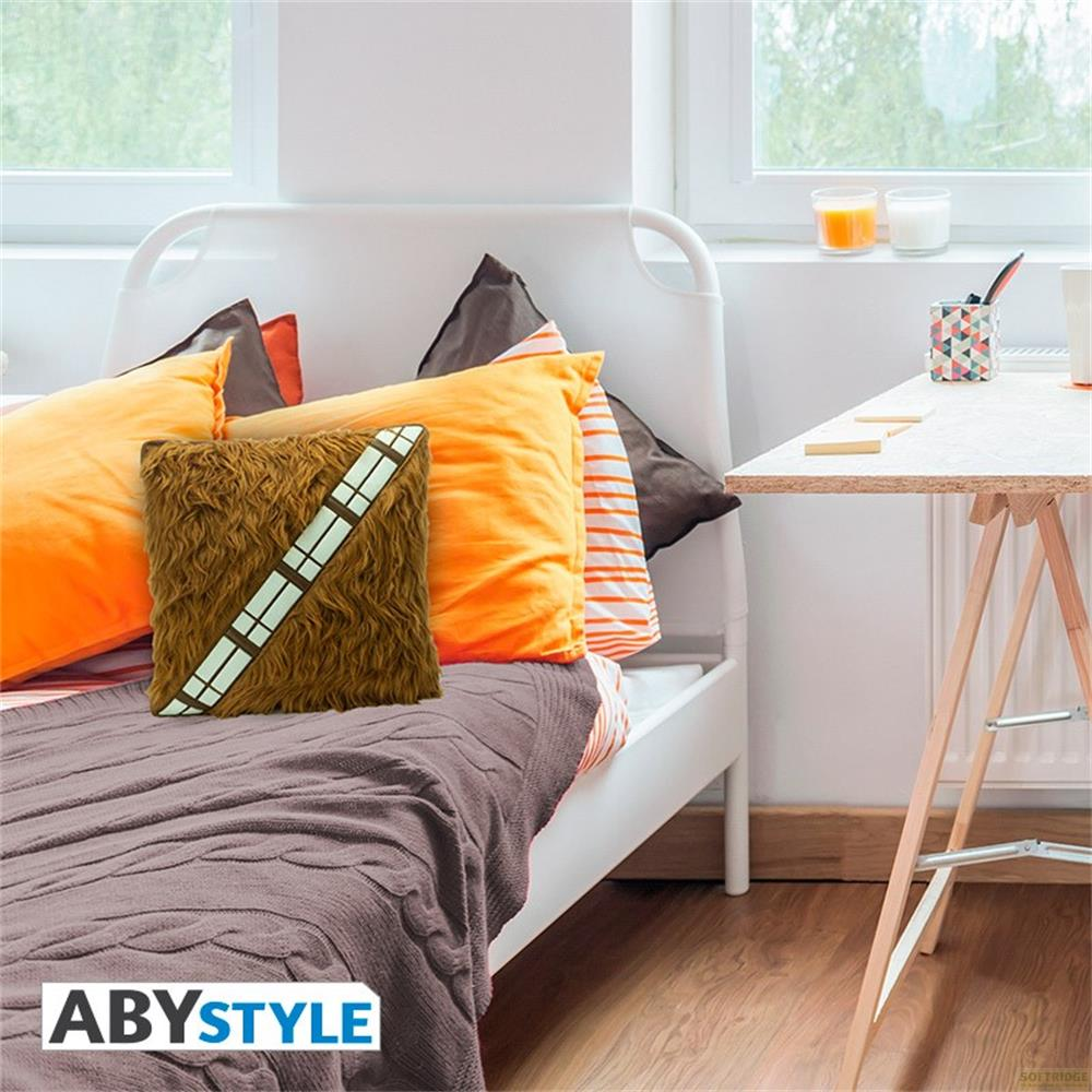 Ein braunes Kissen mit Streifen liegt auf einem Bett mit orangen und braunen Kissen.